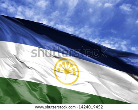 waving flag of Bashkortostan close up against blue sky