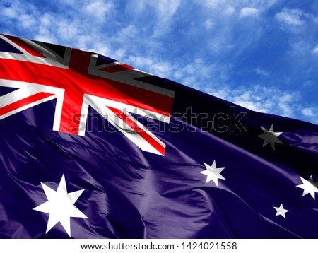 waving flag of Australia close up against blue sky