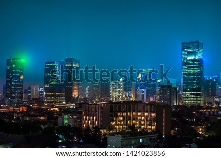 Jakarta city at night with occupancy and beauty illuminates towering business center buildings. Isolated on the concept of business economy and technology in the capital of Indonesia.