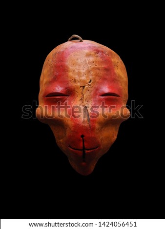 Photo ethnic mask. Mask for holiday ritual and carnival isolated on black background.            