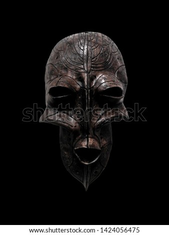 Photo ethnic mask. Mask for holiday ritual and carnival isolated on black background.            