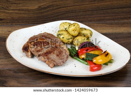 Irish sirloin steak served with baby new potatoes and roast vegetables.