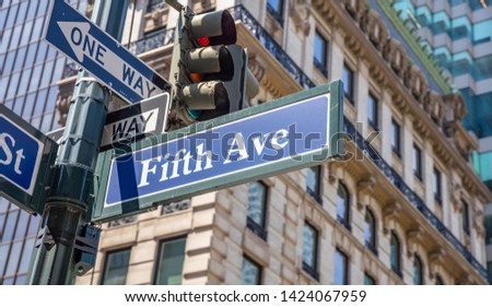 Fifth ave street sign, Manhattan New York downtown. Blue sign on blur buildings facade background,