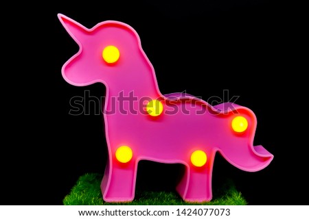 Motion blur. Blurred. Noise. Grain. Close up. Plastic horse pattern with light