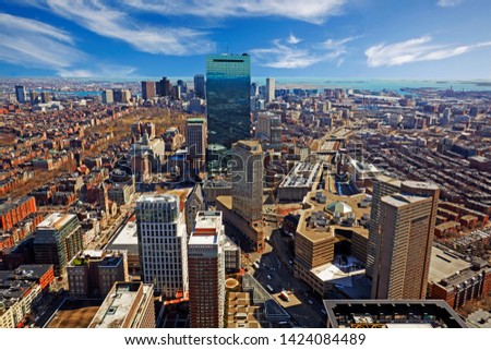 Aerial view of the skyline of downtown  Boston against blue skies in New England, US