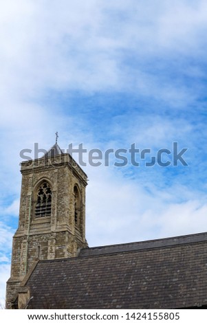 Holy Trinity Church, in Upper Tooting, London, England, on a sunny day with a blue cloudy sky.  Image has copy space.