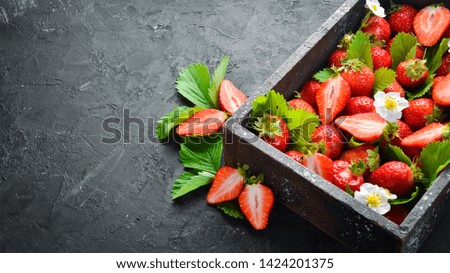 Fresh strawberries in a wooden box. Berries Top view. Free space for your text.