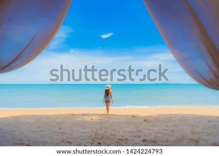 Portrait beautiful young asian woman happy smile relax on the tropical beach sea ocean for leisure travel in holiday vacation