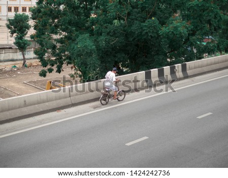 A man ride on bike on the road