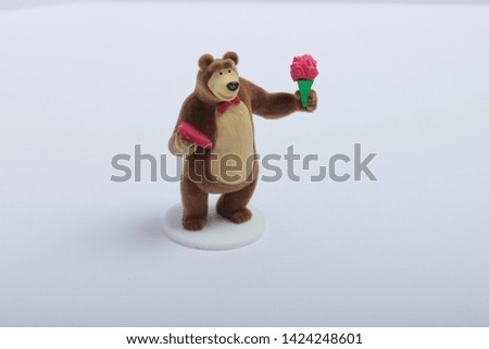 toy bear with flower on white background