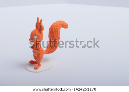 toy red squirrel on white background
