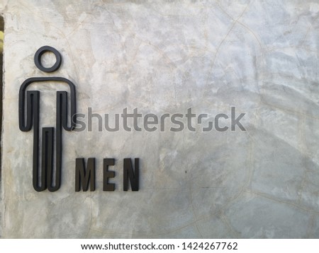 The sign of toilet  male symbol  on cement  wall.