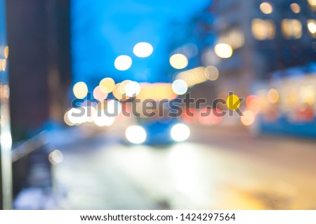 Out-of-focus image of traffic at night.