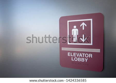 sign in building indicating where the elevator is