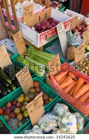 fruit and vegetables displayed in bins on the sidewalk outside a store in Chinatown, Victoria,  British Columbia, Canada