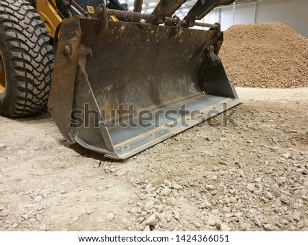 yellow excavator bulldozer working, bucket digging stones, construction equipment