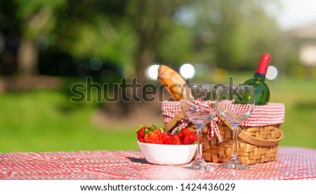 Picnic. bottle of wine with glasses. strawberry.romance. rest and sunny mood