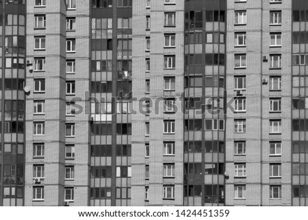 Black and white image of a high-rise apartment building window in a residential area of the city