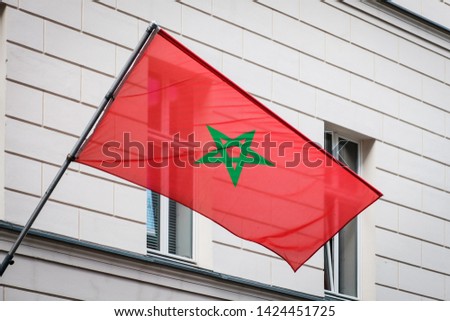 moroccan flag on pole on building - morocco flag