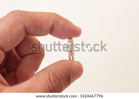 Gold ring in the hands