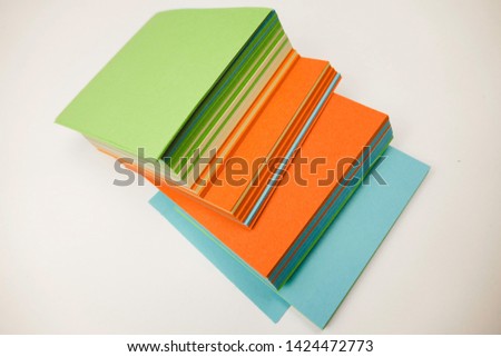 A stack of multicolored note papers on an isolated white background. isolates