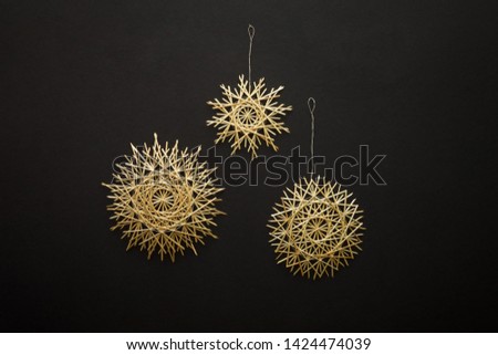 Snowflakes are made of straw on a dark background. Christmas decor. Top view