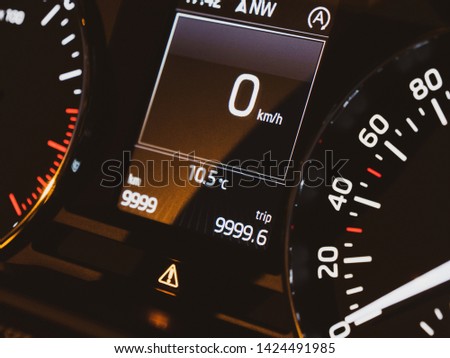 Stationary new modern car speedometer dashboard with 0 kmh current speed on the dot matrix display screen