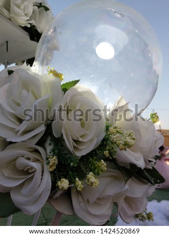 glass ball, blue sky and white artificial roses, wedding design