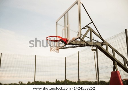 Basket on basketball court and beautiful sky