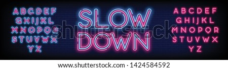 Slow Down neon sign vector with a Brick Wall Background Design template neon text  light banner  neon signboard  nightly bright advertising  light inscription. Vector illustration. Editing Text Neon
