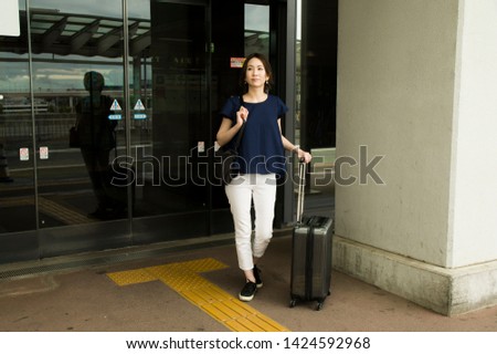 Woman leaving the airport terminal building