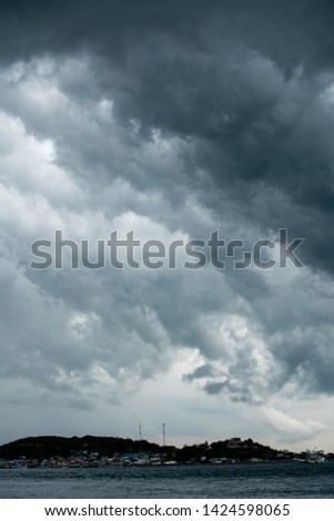 storm cloud background during raining. Dark Clouds. Huge black clouds on dark sky before a thunder-storm.