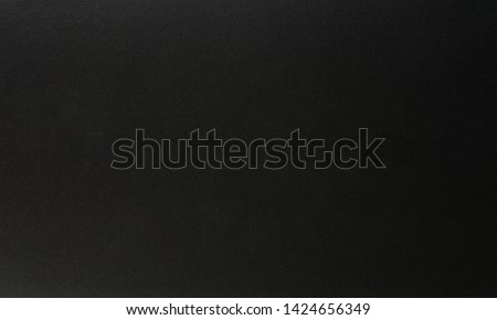 Black matte paper background close up view Royalty-Free Stock Photo #1424656349