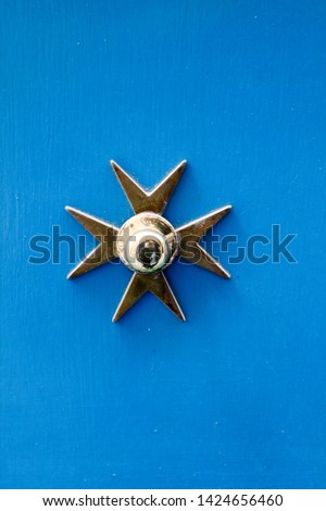 old maltese wooden azure door with Maltese cross handle, Marsaxlokk, Malta