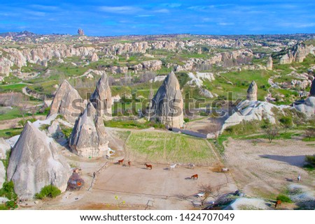 Photo taken in Turkey. The pictures are a fantastic landscape of mountain Cappadocia. In the foreground is a horse farm.