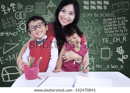 Happy family with mother and children in class