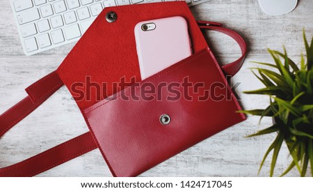smartphone with red wallet on the white wood background