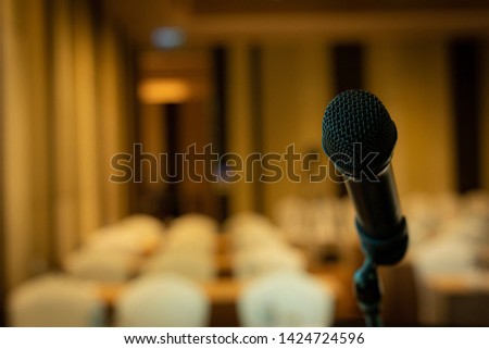 Microphone on the stage with blurred background, presentation,announcement, live report concept.