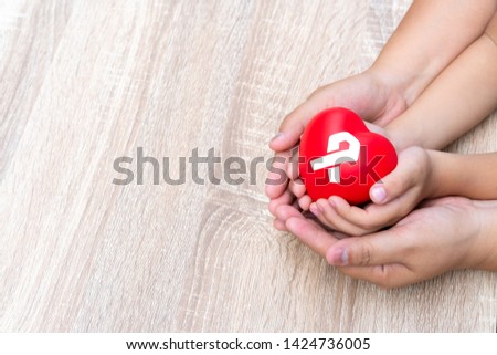 Medical icon concept in the heart of family's hands