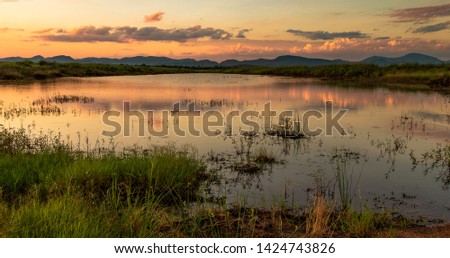Beautiful landscape image of colorful sunset with cloud reflection in water