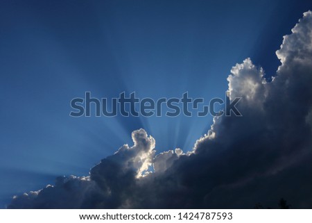 Thunderclouds pull in front of the sun.