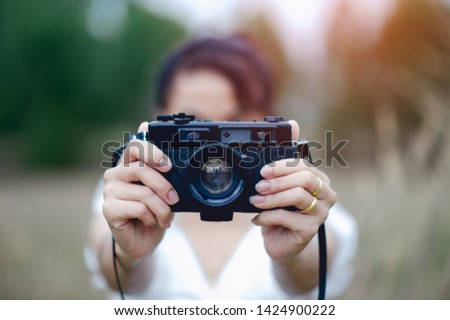 Hand and camera of the photographer Holding and carrying the camera to take pictures