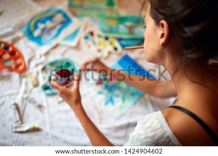 Young female artist enjoy in painting