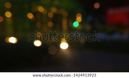 Blurry Light at Night with raind drop at transpatent plastic wall for background, wallpaper, backdrop etc