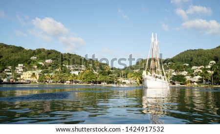 Tropical ocean and beach with sail boat yacht in the Tobago Cays, Saint Vincent and the Grenadines, Caribbean.