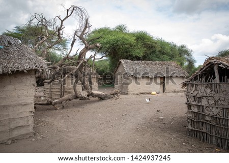 Traditional hut houses of Maasai people Royalty-Free Stock Photo #1424937245