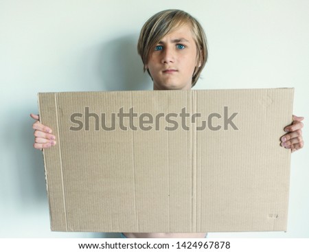 Boy Showing Blank Signboard with Empty Copyspace