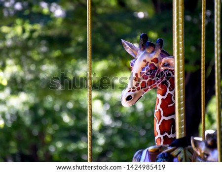 giraffe ride on carousel with brass poles and copy space