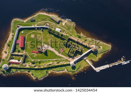 Russia, St. Petersburg, Aerial photography of the Oreshek fortress in Schlesselburg, sunny weather, Neva river, green grass, wall of fortress