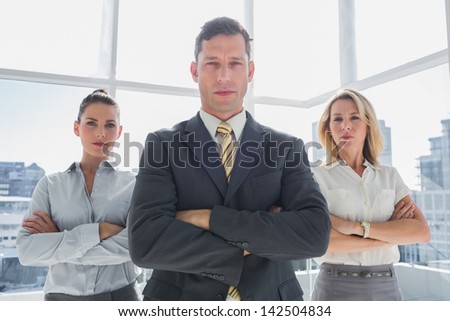 Group of confident business people standing together in their office